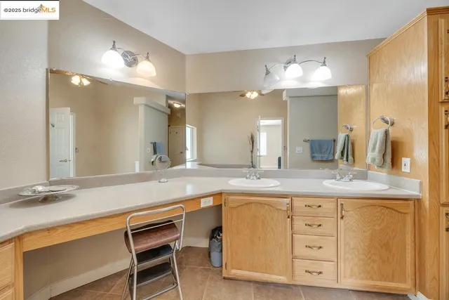 a spacious bathroom with a granite countertop sink a mirror and a