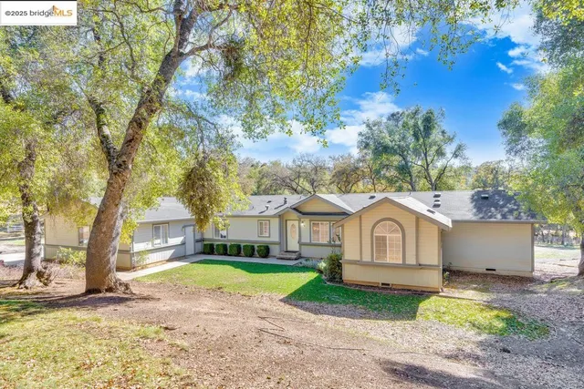 a view of white house with a yard
