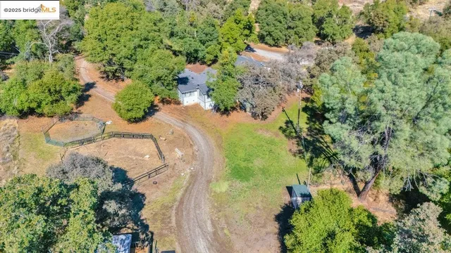 an aerial view of a house with a yard