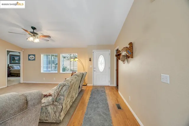 a view of hallway with furniture and a chandelier