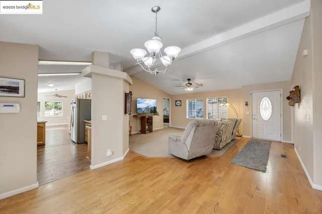 a living room with furniture and kitchen view