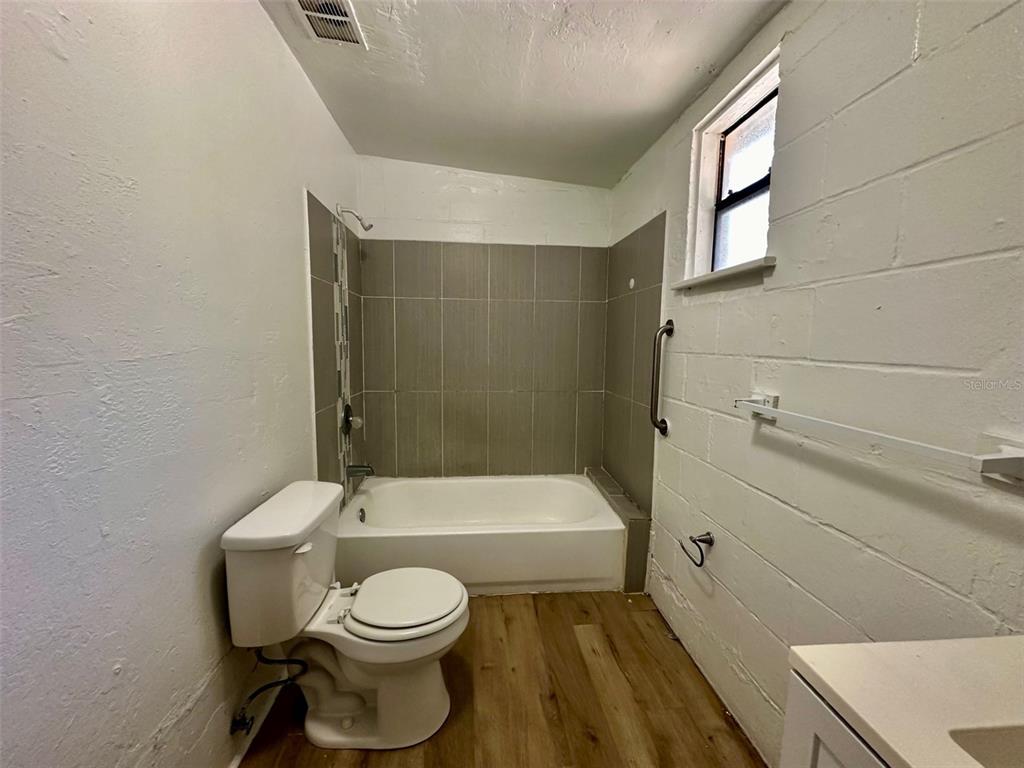 647 Northeast Waldo Road Gainesville, FL 32641 - Photo 12 of 25 a bathroom with a toilet a sink and bathtub