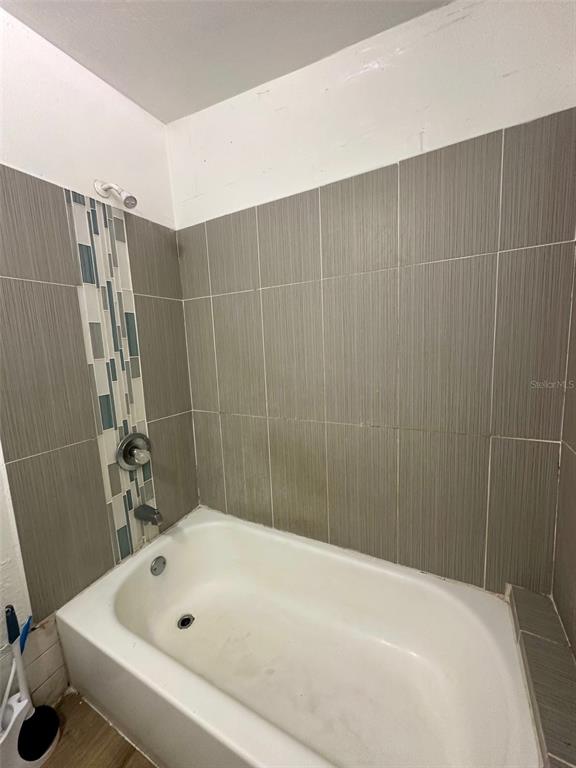 647 Northeast Waldo Road Gainesville, FL 32641 - Photo 13 of 25 a bathroom with a bathtub and shower