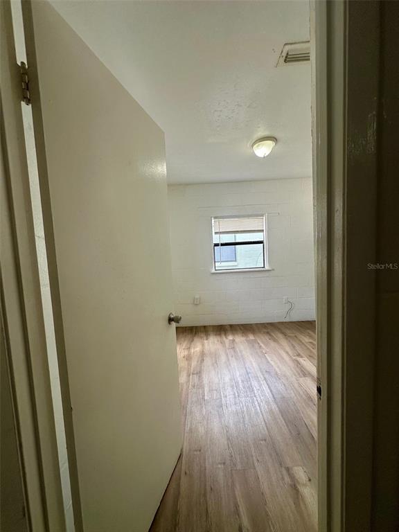 647 Northeast Waldo Road Gainesville, FL 32641 - Photo 14 of 25 a view of a room with wooden floor and window