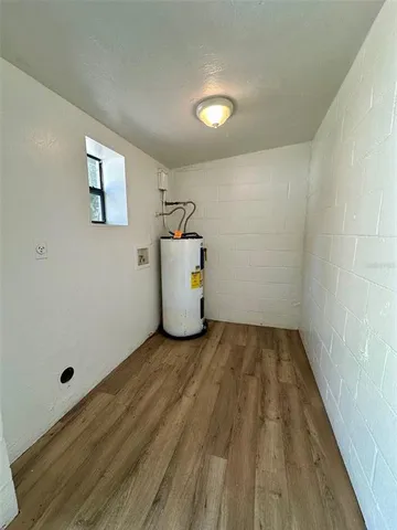 a view of a room with wooden floor