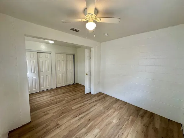 a view of an empty room and wooden floor