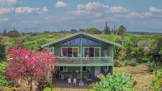 a view of a house with yard and sitting area