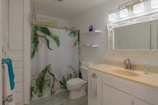 a bedroom with a bed and large windows