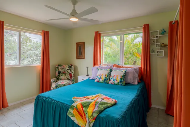 a living room with furniture a flat screen tv and wooden floor