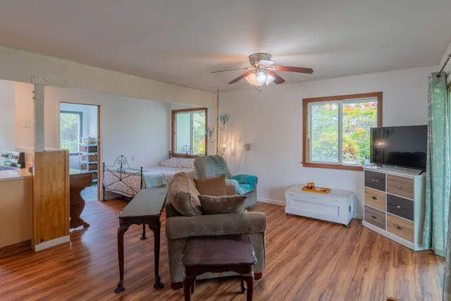 a living room with furniture and a chandelier