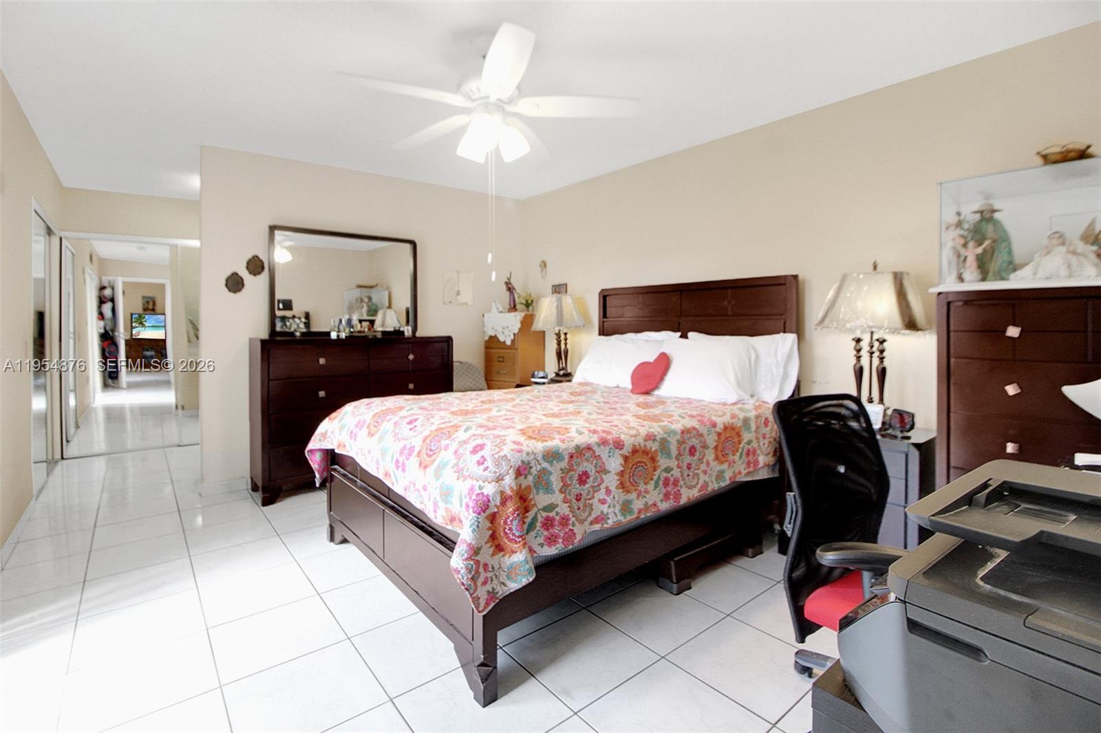 11942 Southwest 210th Street Miami, FL 33177 - Photo 13 of 19 a bedroom with a bed and dresser