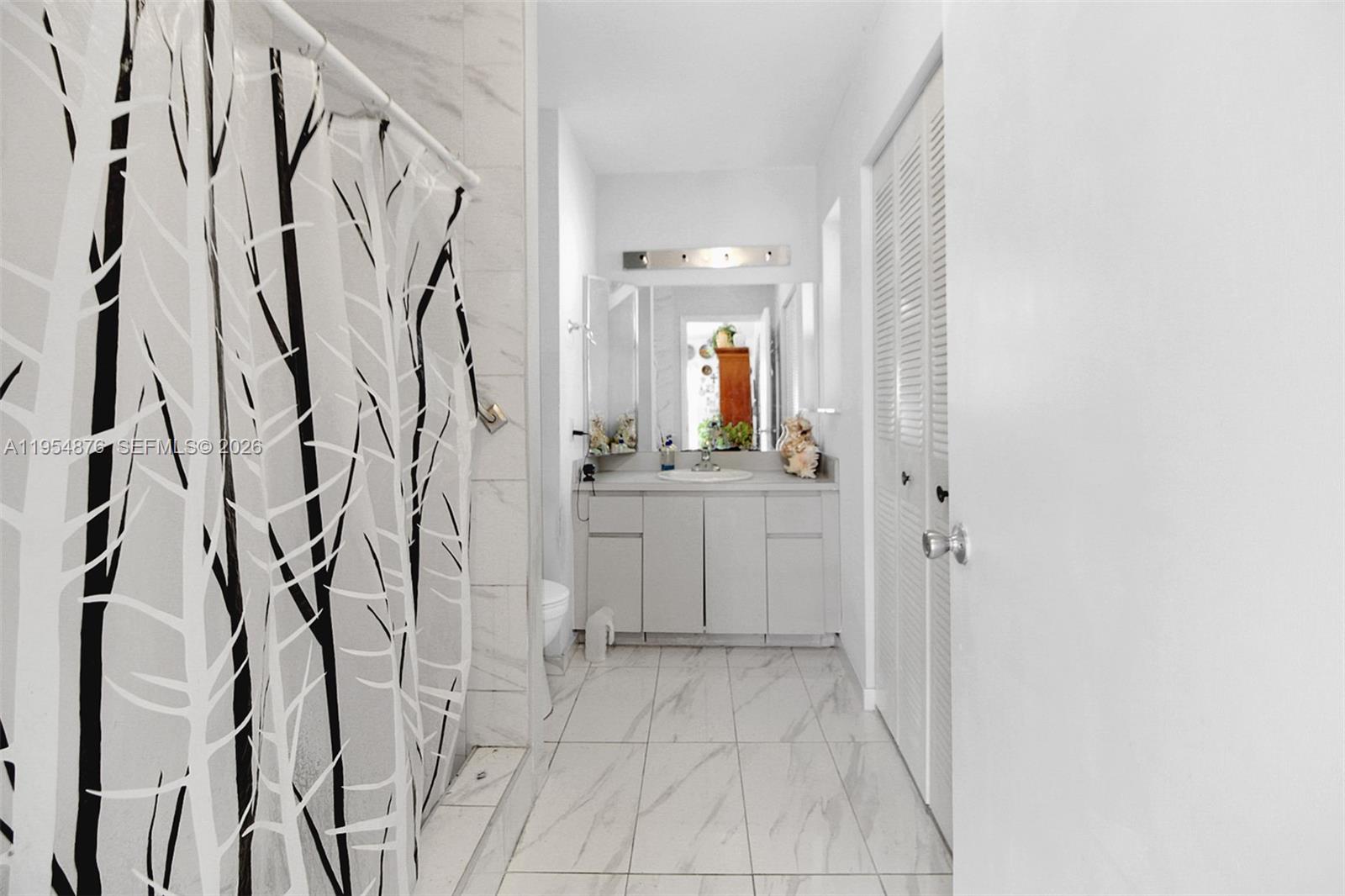 11942 Southwest 210th Street Miami, FL 33177 - Photo 14 of 19 a bathroom with a sink and a mirror