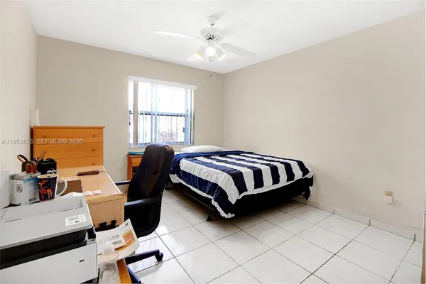 a large white bathroom with a sink and mirror