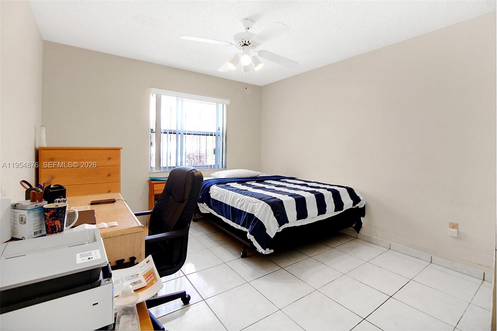 11942 Southwest 210th Street Miami, FL 33177 - Photo 15 of 19 a bedroom with a bed and window