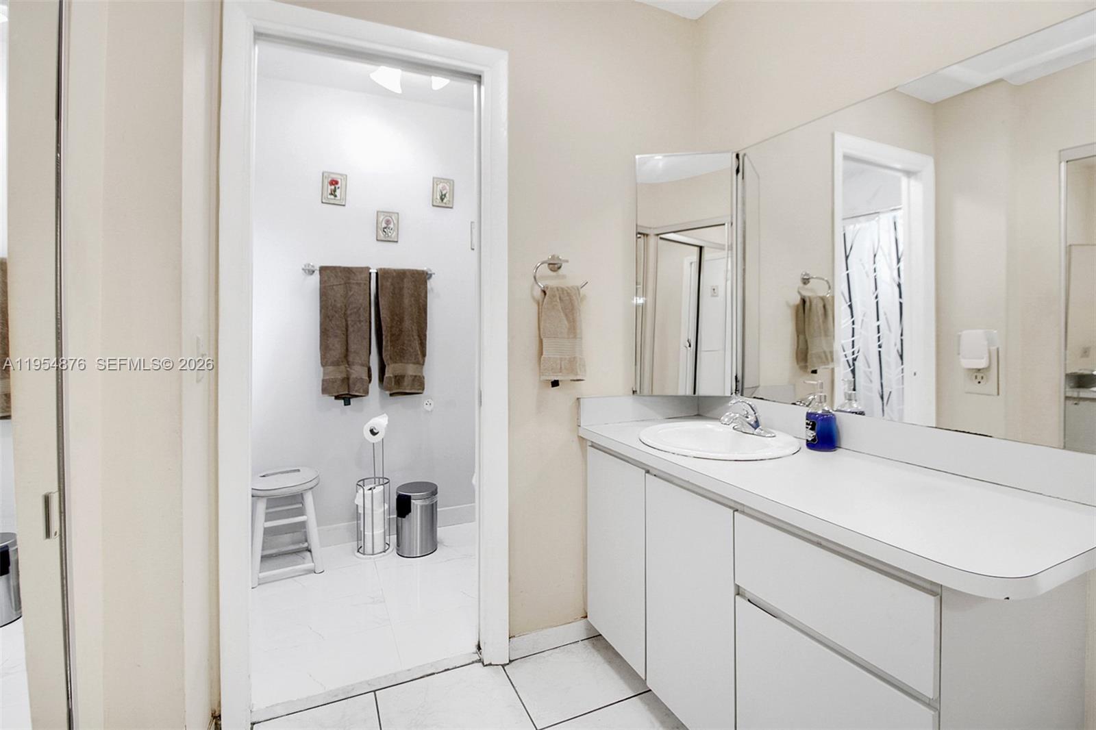 11942 Southwest 210th Street Miami, FL 33177 - Photo 17 of 19 a bathroom with a sink and a mirror