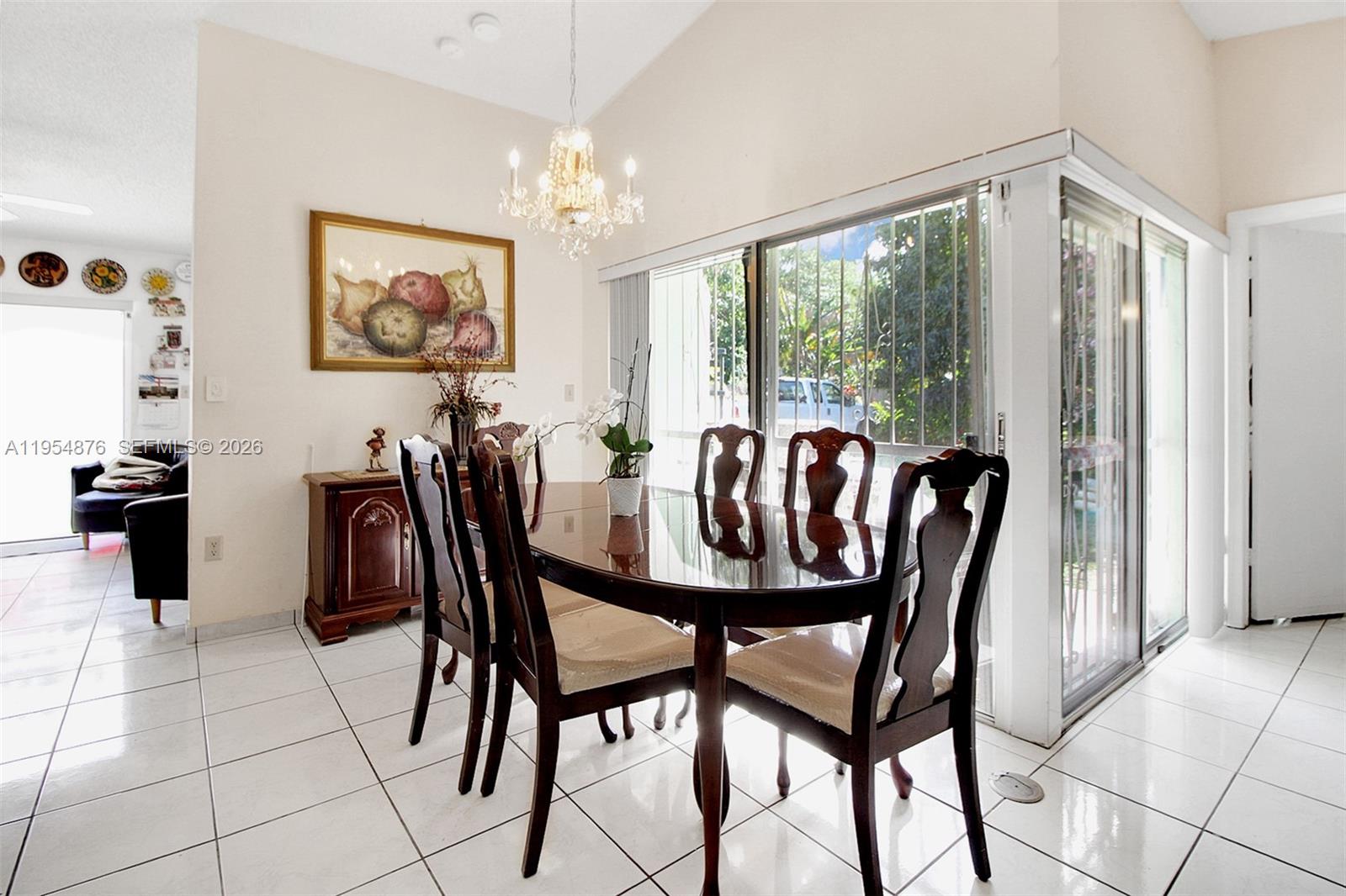 11942 Southwest 210th Street Miami, FL 33177 - Photo 10 of 19 a view of a dining room with furniture window and outside view