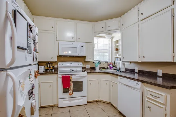a kitchen with cabinets appliances and a sink