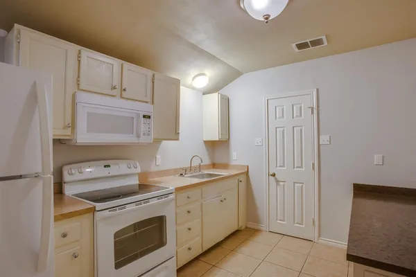 a kitchen with a sink stove and cabinets