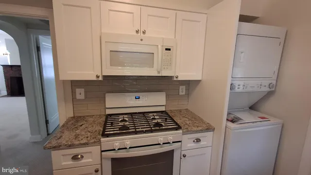 a stove top oven sitting inside of a kitchen