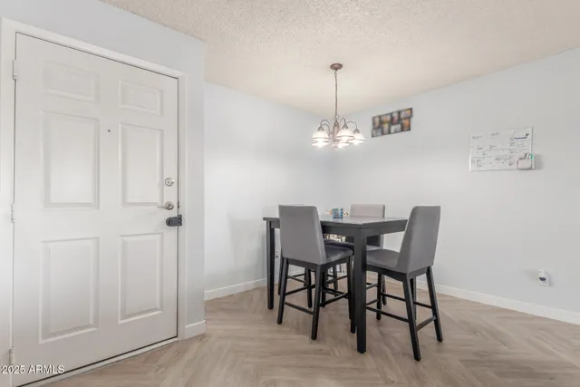 a view of a dining room with furniture and chandelier