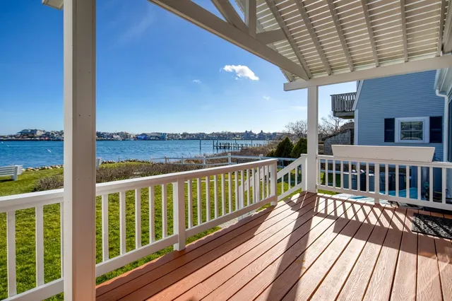 a view of balcony with wooden floor and fence