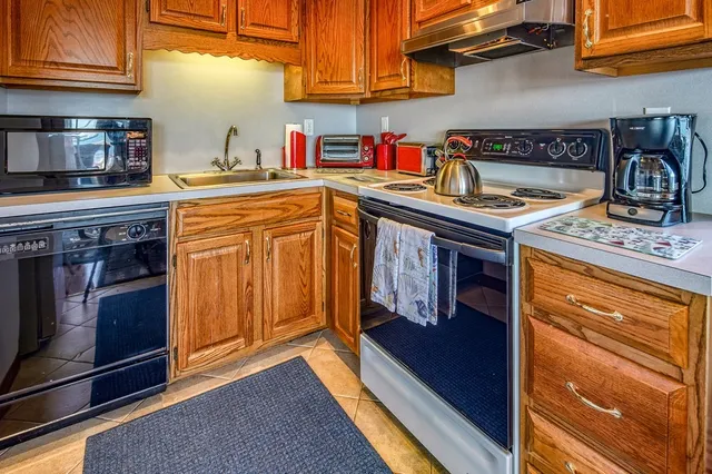 a bedroom with a bed and dresser with mirror