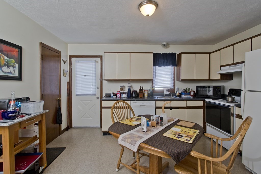 20-22 Gold Street Springfield, MA 01107 - Photo 22 of 27 a kitchen with a sink refrigerator and cabinets