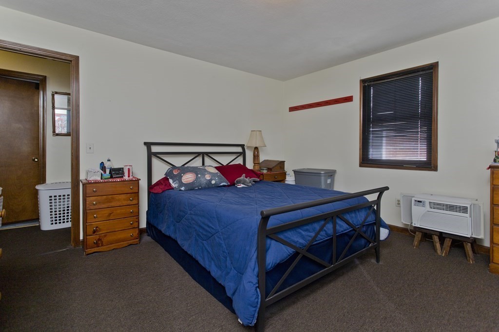 20-22 Gold Street Springfield, MA 01107 - Photo 26 of 27 a bedroom with a bed and a table in it