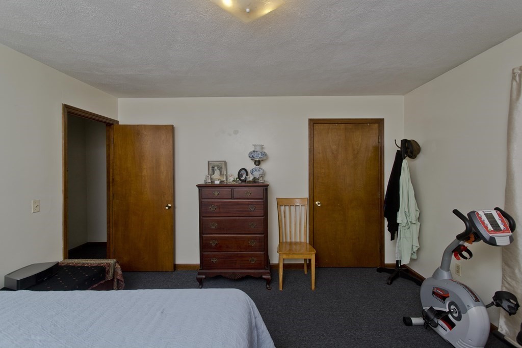 20-22 Gold Street Springfield, MA 01107 - Photo 9 of 27 a bedroom with a closet and a mirror