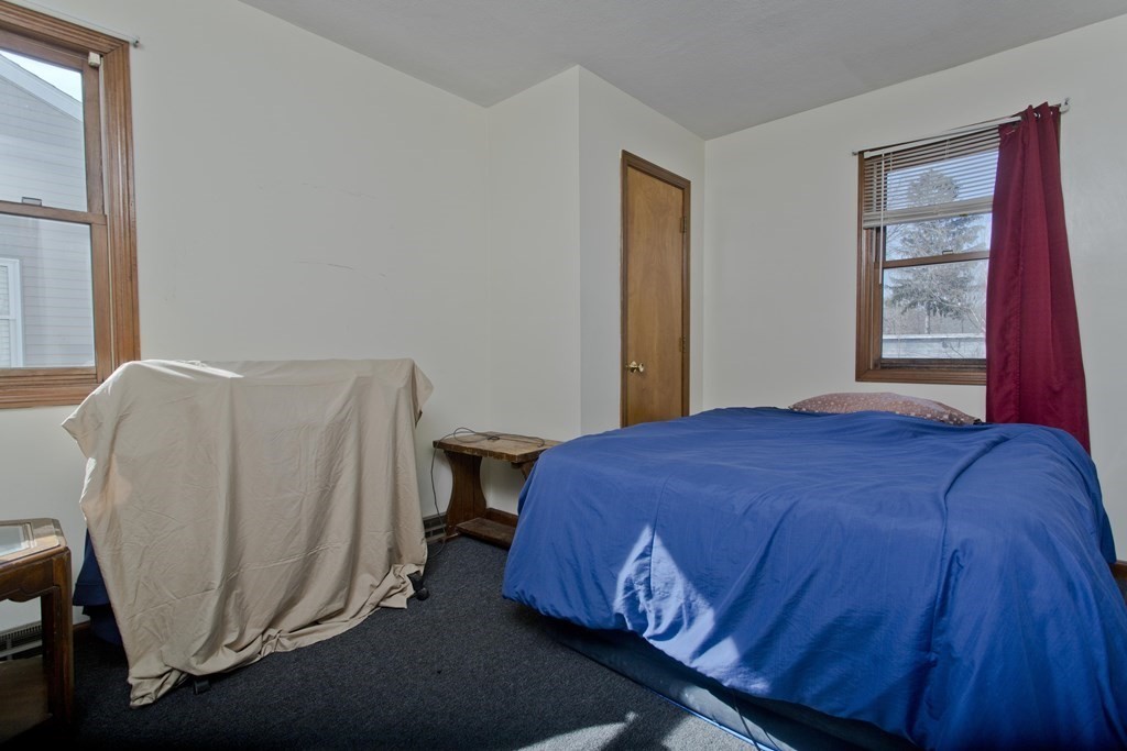 20-22 Gold Street Springfield, MA 01107 - Photo 10 of 27 a bed sitting in a bedroom next to a window