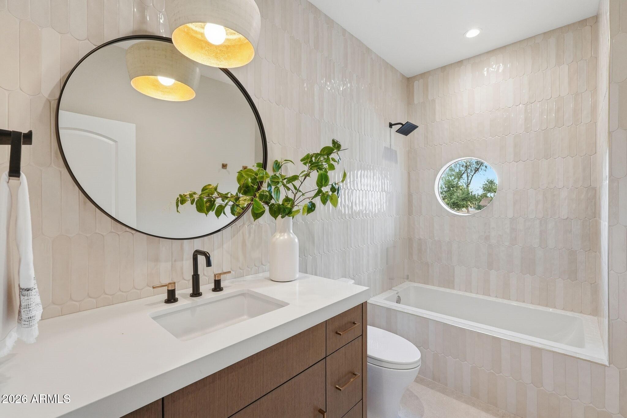 7475 East Gainey Ranch Road, Unit 7 Scottsdale, AZ 85258 - Photo 51 of 77 a bathroom with a sink a toilet and a mirror