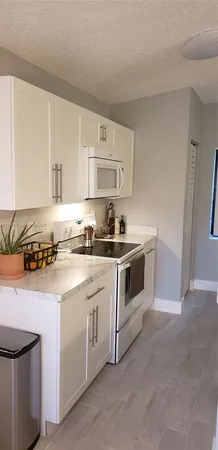 a white stove top oven sitting inside of a kitchen