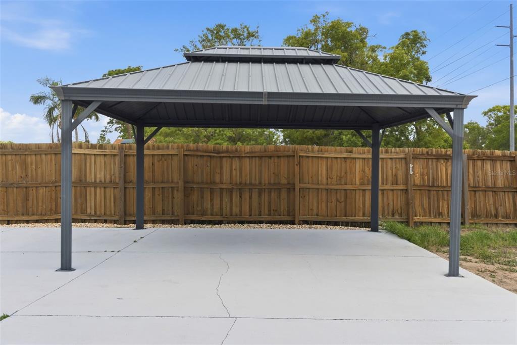 4966 Keysville Avenue Spring Hill, FL 34608 - Photo 42 of 48 a backyard of a house with table and chairs