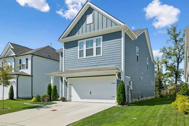 a front view of a house with a yard and garage