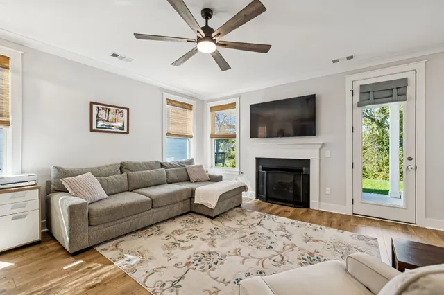 a living room with furniture a fireplace and a flat screen tv
