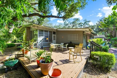 a view of a backyard with plants and a patio