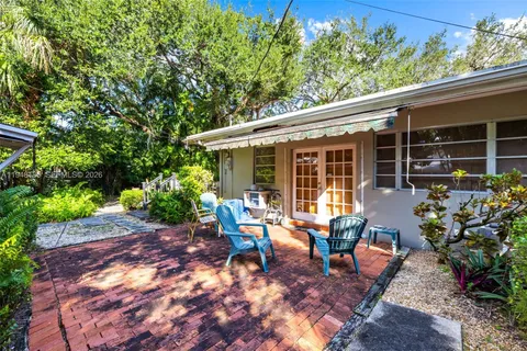 a view of a house with backyard sitting area and garden