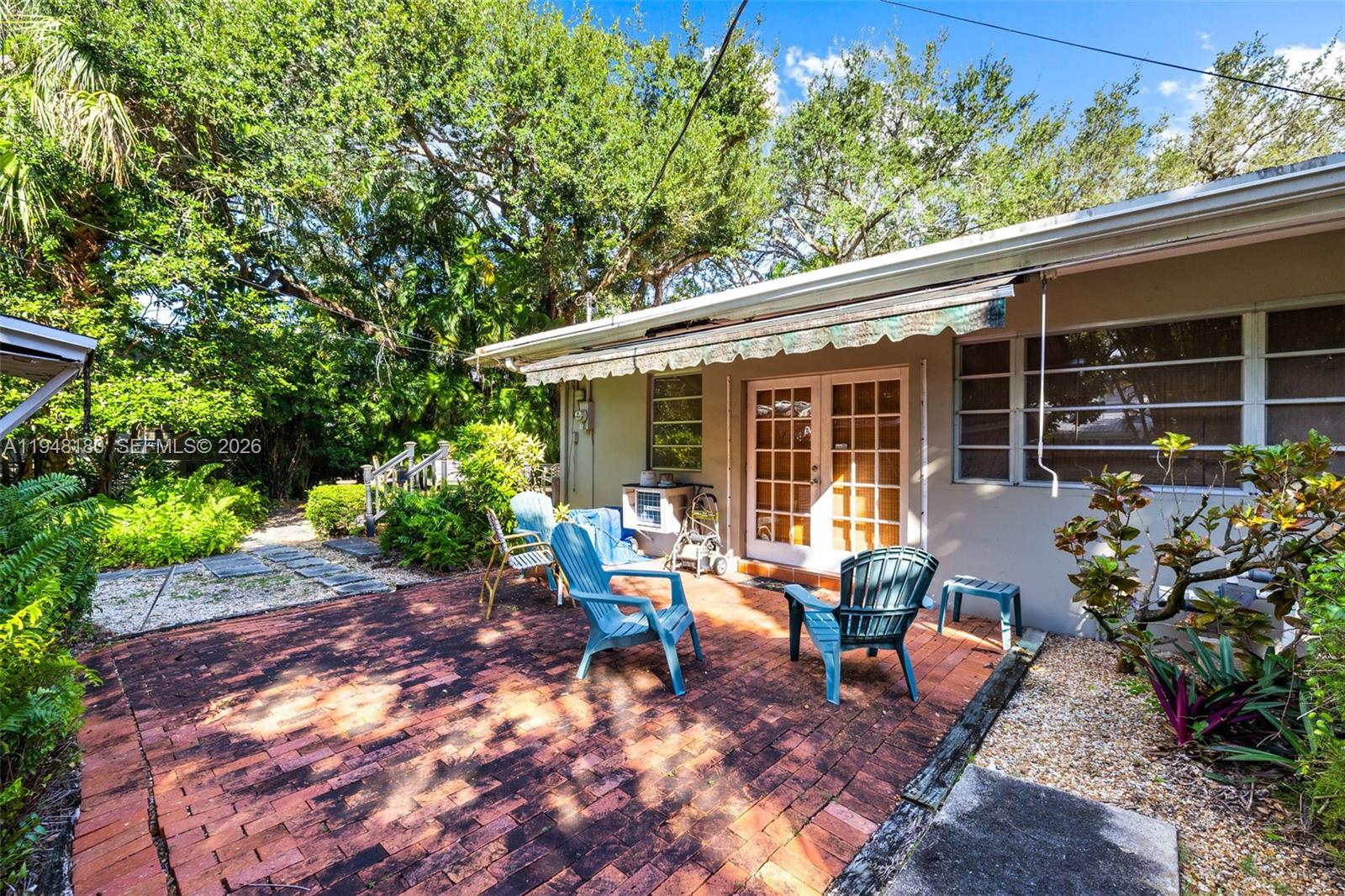 5335 Southwest 74th Street Miami, FL 33143 - Photo 10 of 12 a view of a house with backyard sitting area and garden