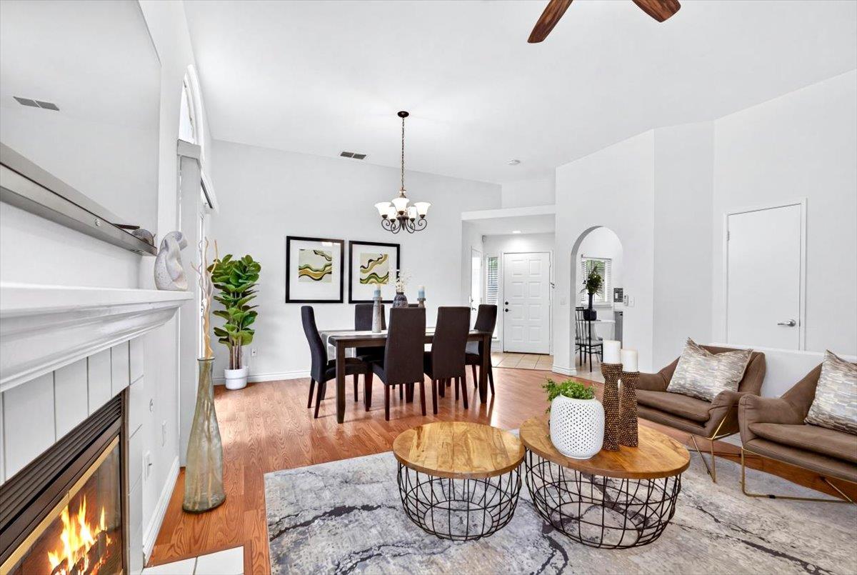 4353 Country Run Way Antelope, CA 95843 - Photo 12 of 28 a dining room with furniture a chandelier and wooden floor