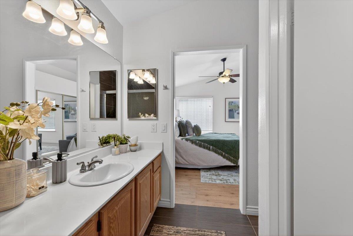 4353 Country Run Way Antelope, CA 95843 - Photo 16 of 28 a en suite bathroom with a granite countertop sink and a mirror