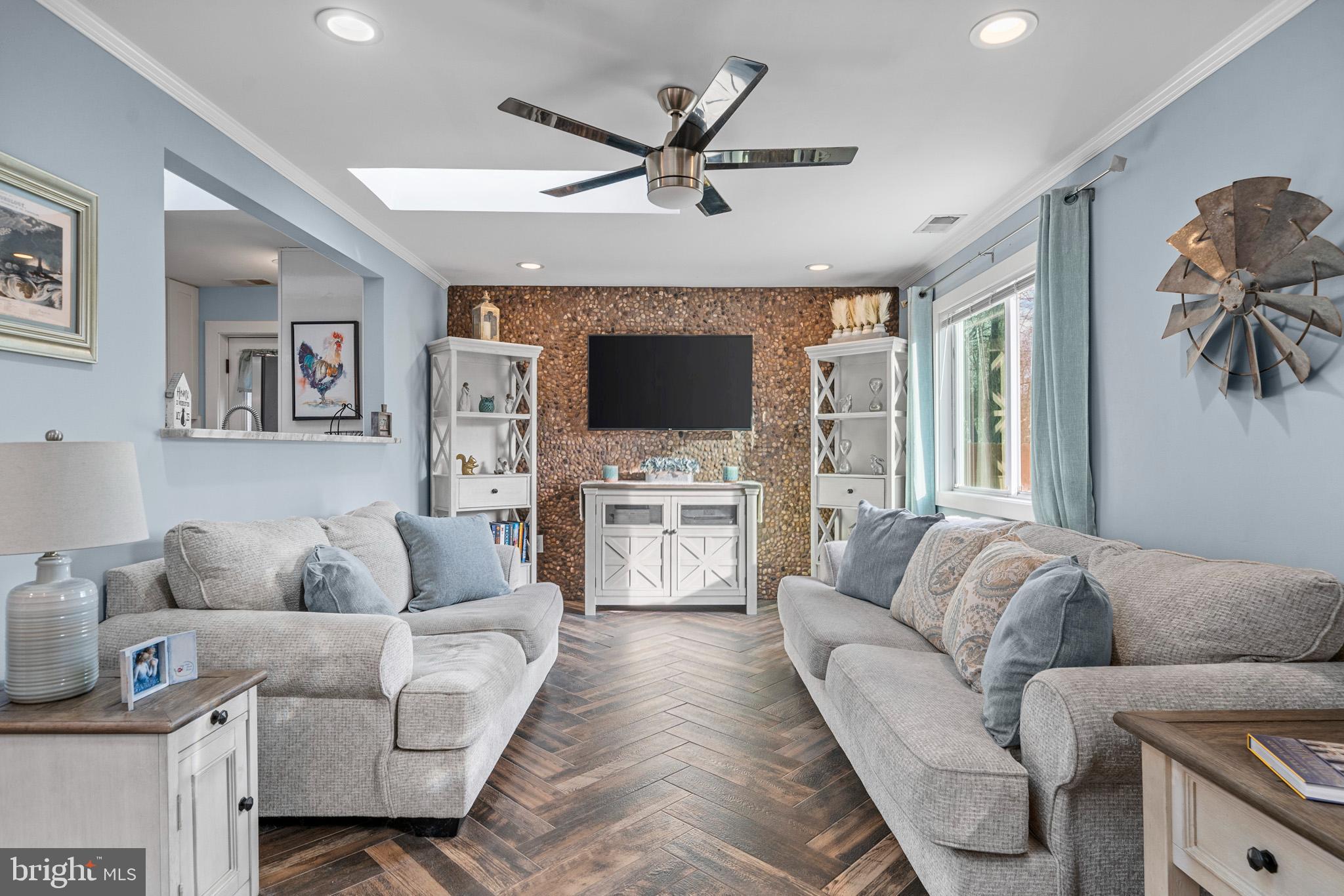 317 Biddle Road Accokeek, MD 20607 - Photo 11 of 44 a living room with furniture a ceiling fan and a flat screen tv