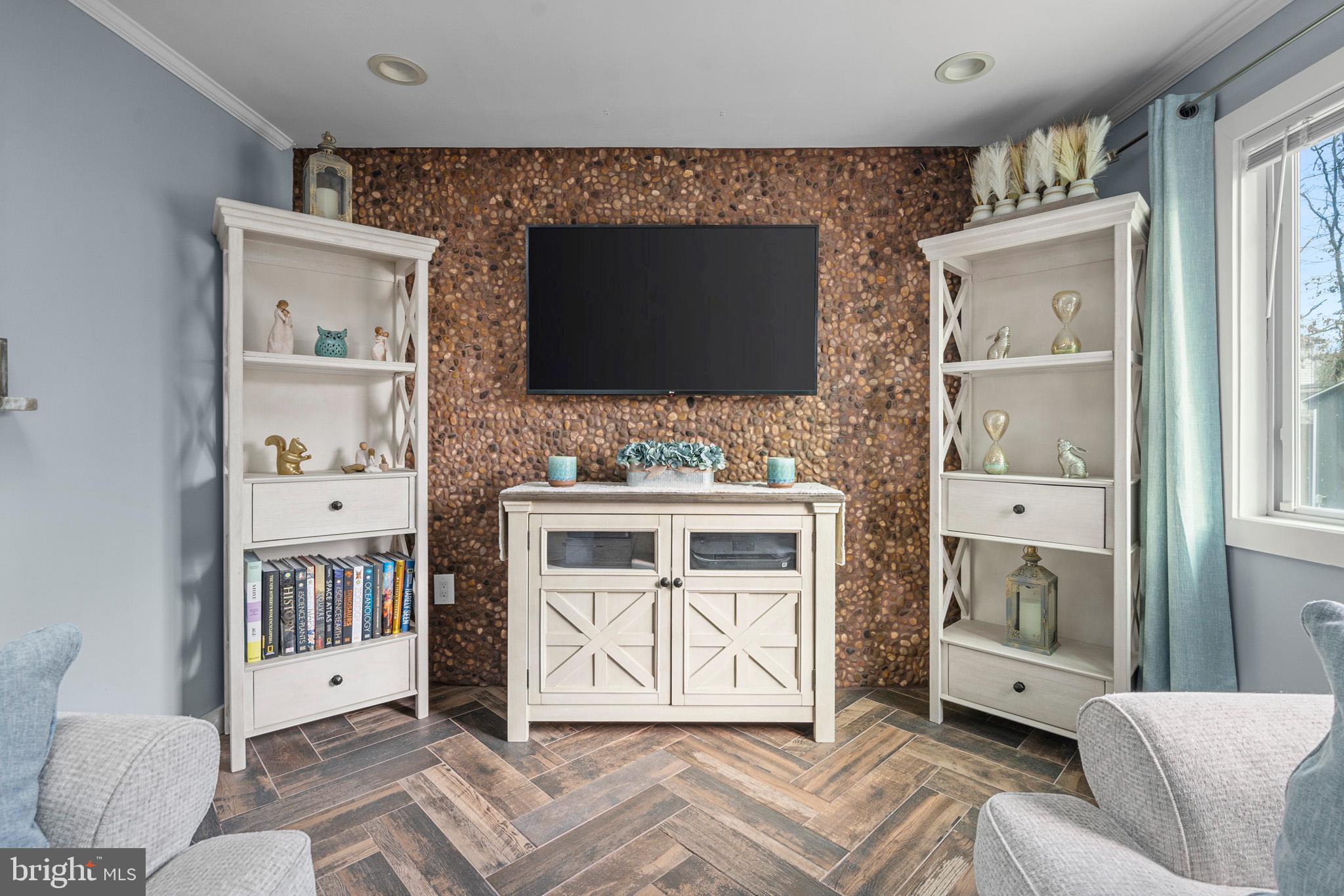 317 Biddle Road Accokeek, MD 20607 - Photo 12 of 44 a living room with furniture a flat screen tv and a fireplace