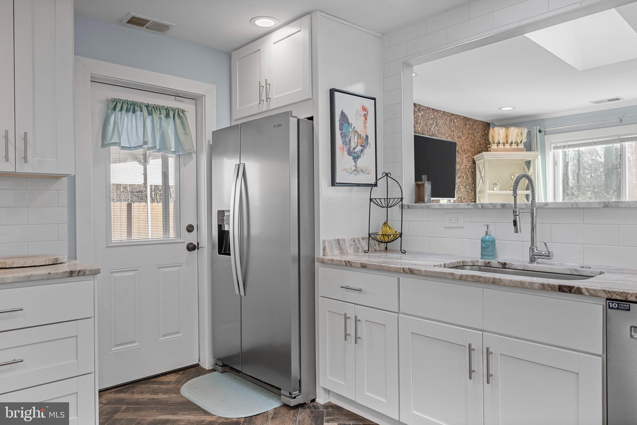 317 Biddle Road Accokeek, MD 20607 - Photo 13 of 44 a bathroom with a granite countertop sink toilet and shower