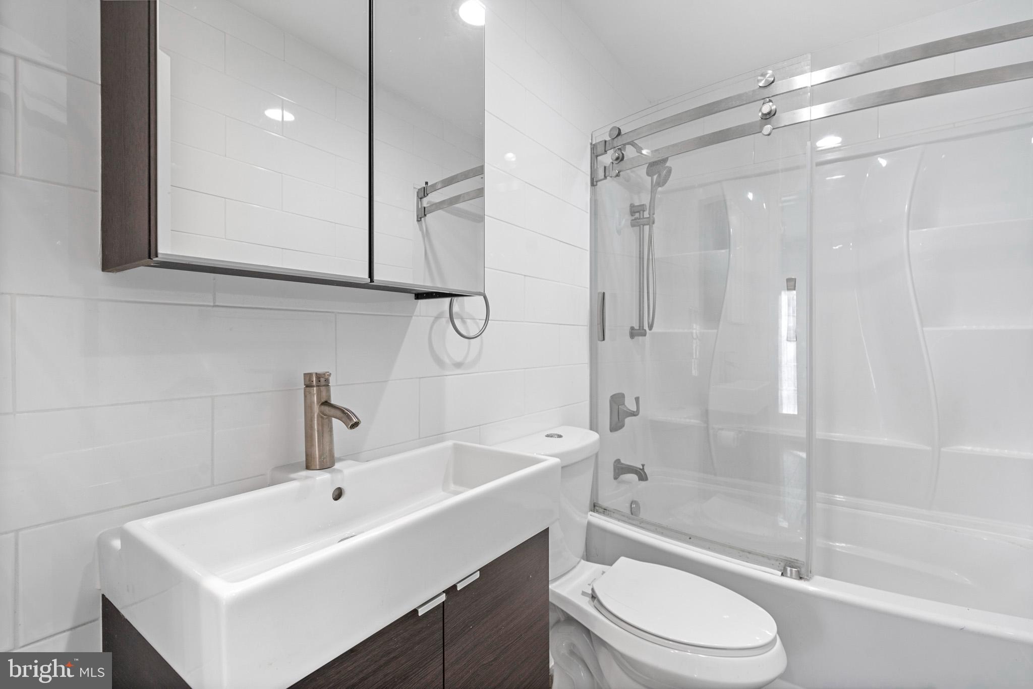 317 Biddle Road Accokeek, MD 20607 - Photo 28 of 44 a bathroom with a sink a toilet and shower