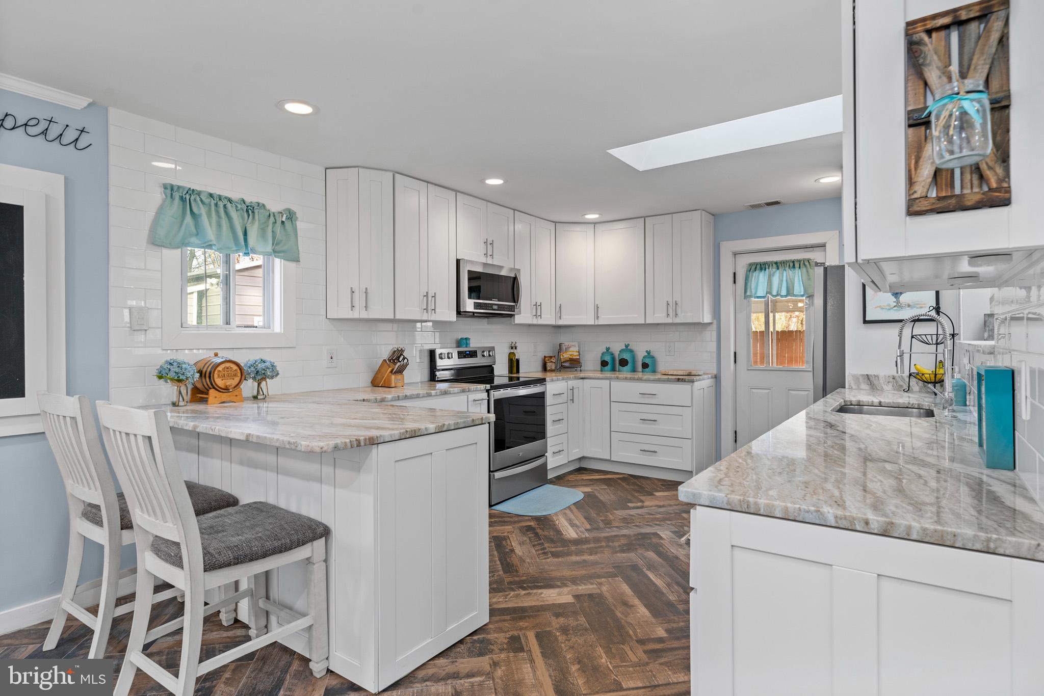 317 Biddle Road Accokeek, MD 20607 - Photo 3 of 44 a kitchen with granite countertop white cabinets and appliances