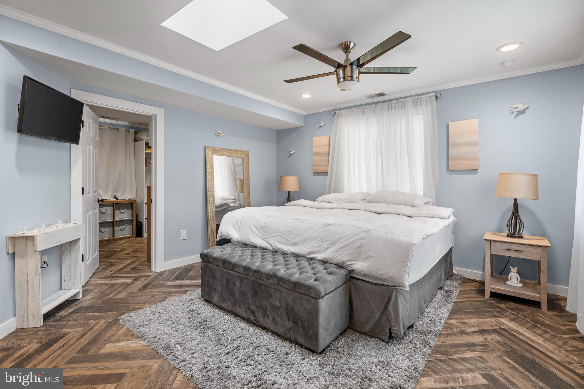 317 Biddle Road Accokeek, MD 20607 - Photo 4 of 44 a bedroom with a bed and a chandelier