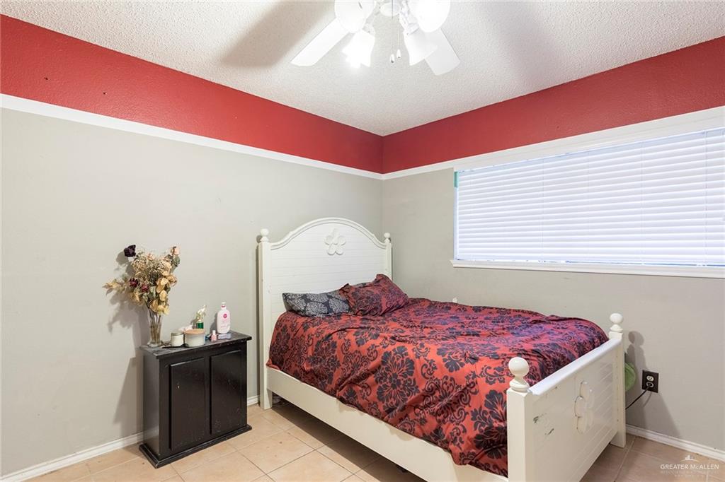 2801 Hawk Avenue McAllen, TX 78504 - Photo 13 of 19 a bed sitting in a bedroom next to a window
