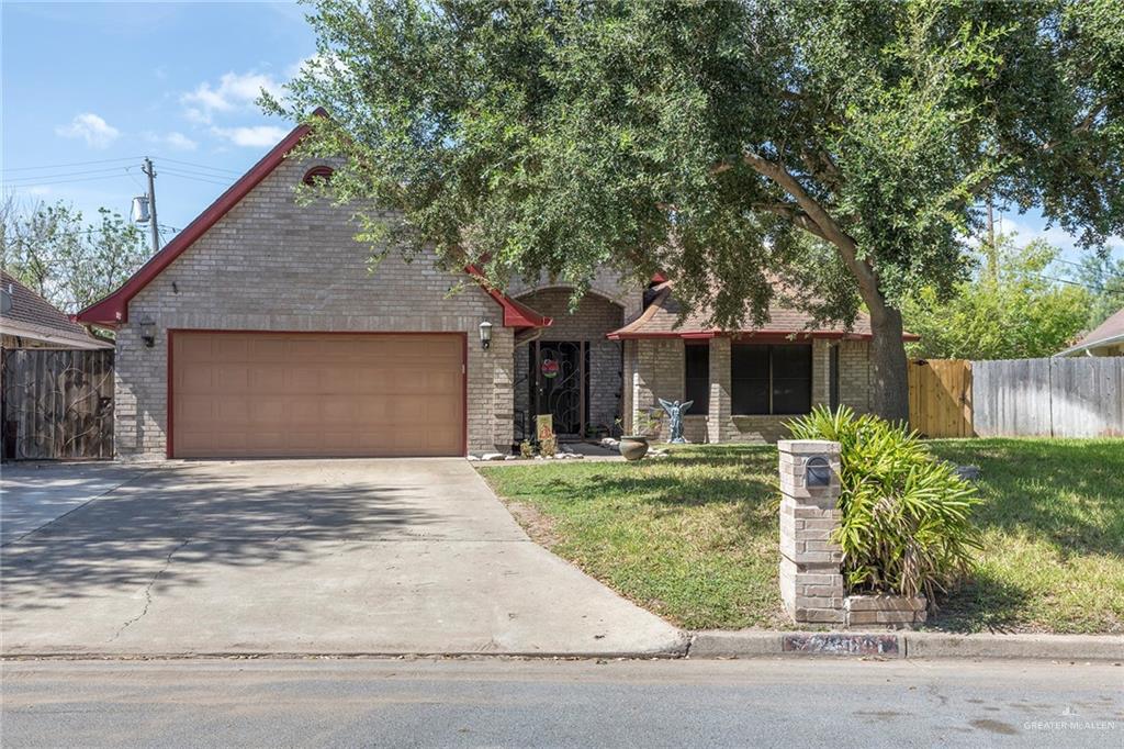 2801 Hawk Avenue McAllen, TX 78504 - Photo 19 of 19 a front view of a house with a yard and potted plants