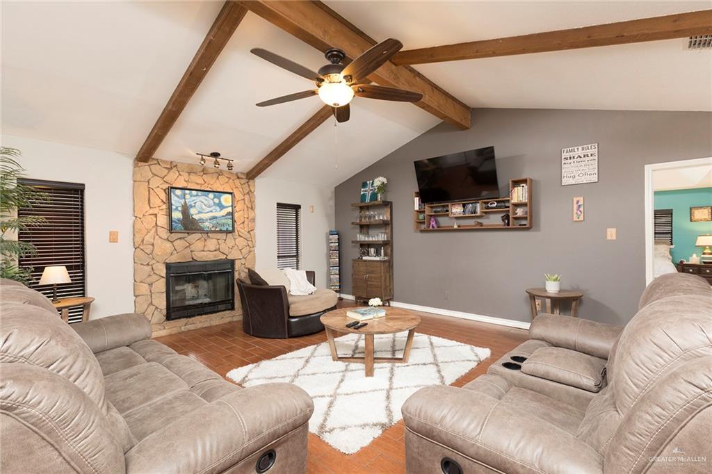 2801 Hawk Avenue McAllen, TX 78504 - Photo 5 of 19 a living room with furniture a flat screen tv and a fireplace