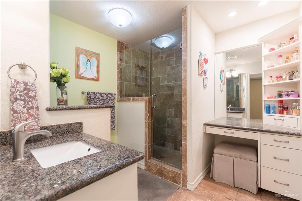 2801 Hawk Avenue McAllen, TX 78504 - Photo 10 of 19 a bathroom with a granite countertop sink a toilet and shower